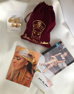 Cargar imagen en el visor de la galería, Marketing materials layout for Jarlia By Jolina featuring gold fan-shaped earrings on a branded card, a dark red velvet pouch with gold logo, and promotional flyers with images of a model adorned in Jarlia&#39;s jewelry, all arranged neatly on a white surface.
